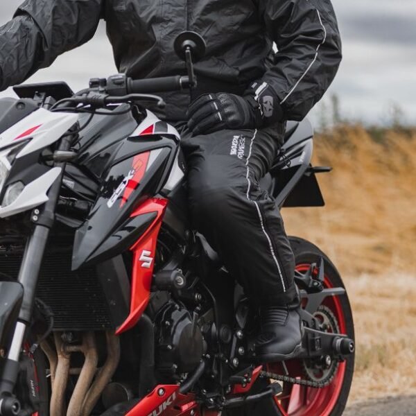 motorcycle rider sat on the bike wearing waterprof gear